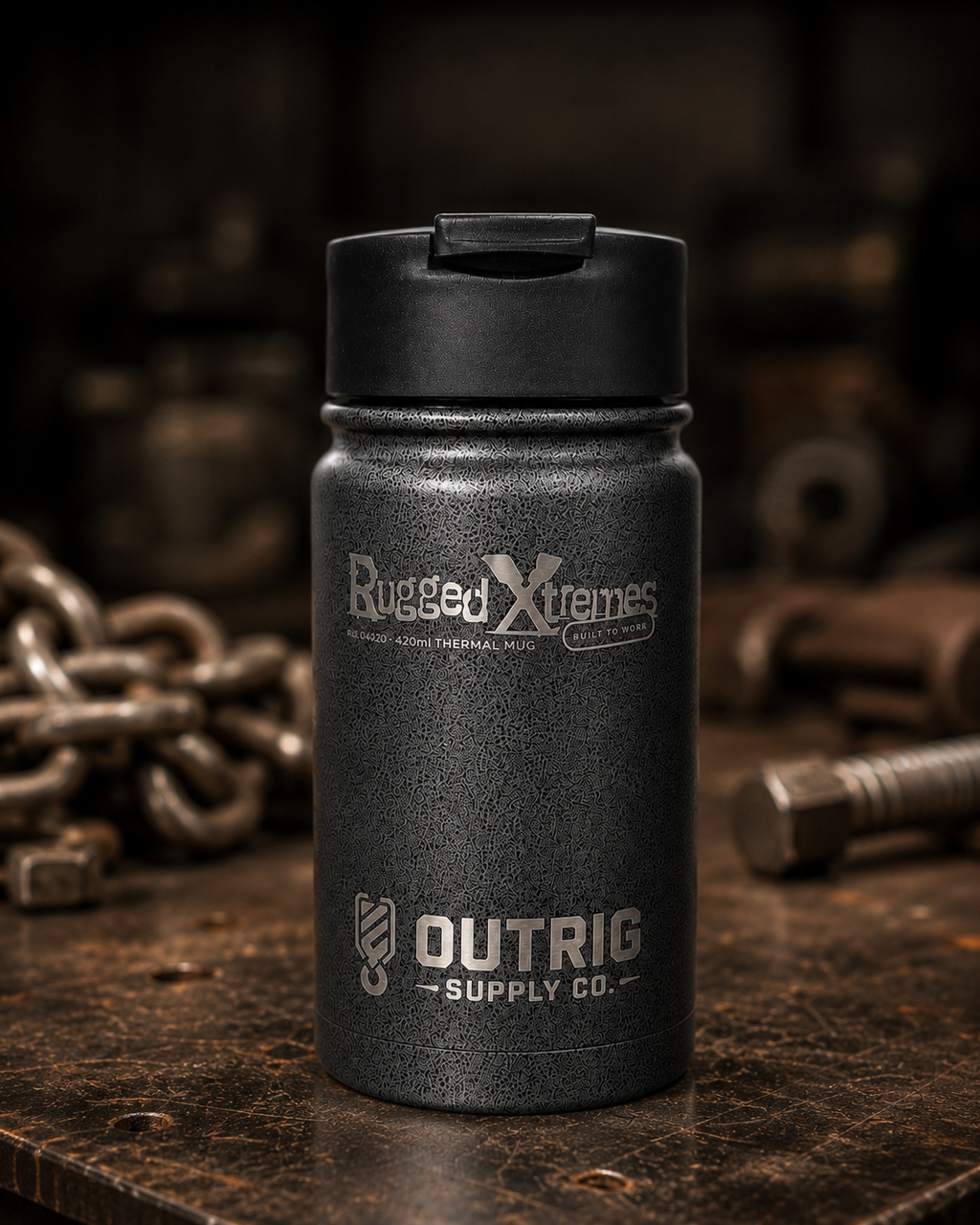 Rugged Xtremes 420ml thermal mug with Outrig Supply Co branding in an industrial setting.