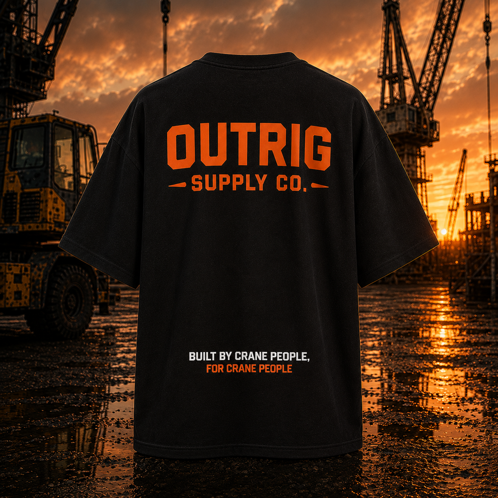 Black t-shirt with 'OUTRIG SUPPLY CO.' text in orange and white, set against a construction site backdrop.