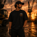 Man standing on a construction site with cranes and sunset in the background
