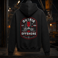 Back view of the black Outrig Offshore Crew Hoodie with offshore vessel and rig artwork in a dark industrial workshop