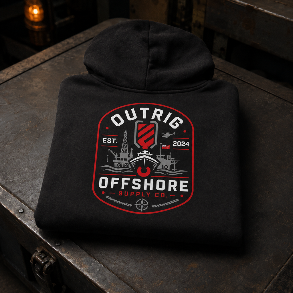 Folded black Outrig Offshore Crew Hoodie with the full offshore back artwork displayed on a dark steel workbench