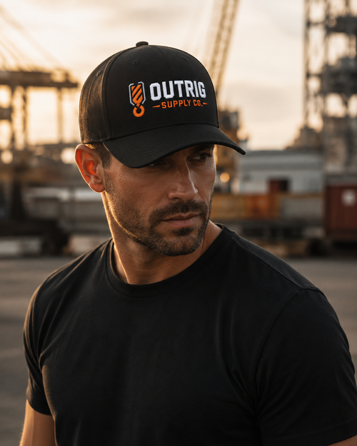 Additional view of the black Outrig Core Flexfit Cap with orange-and-white branding.