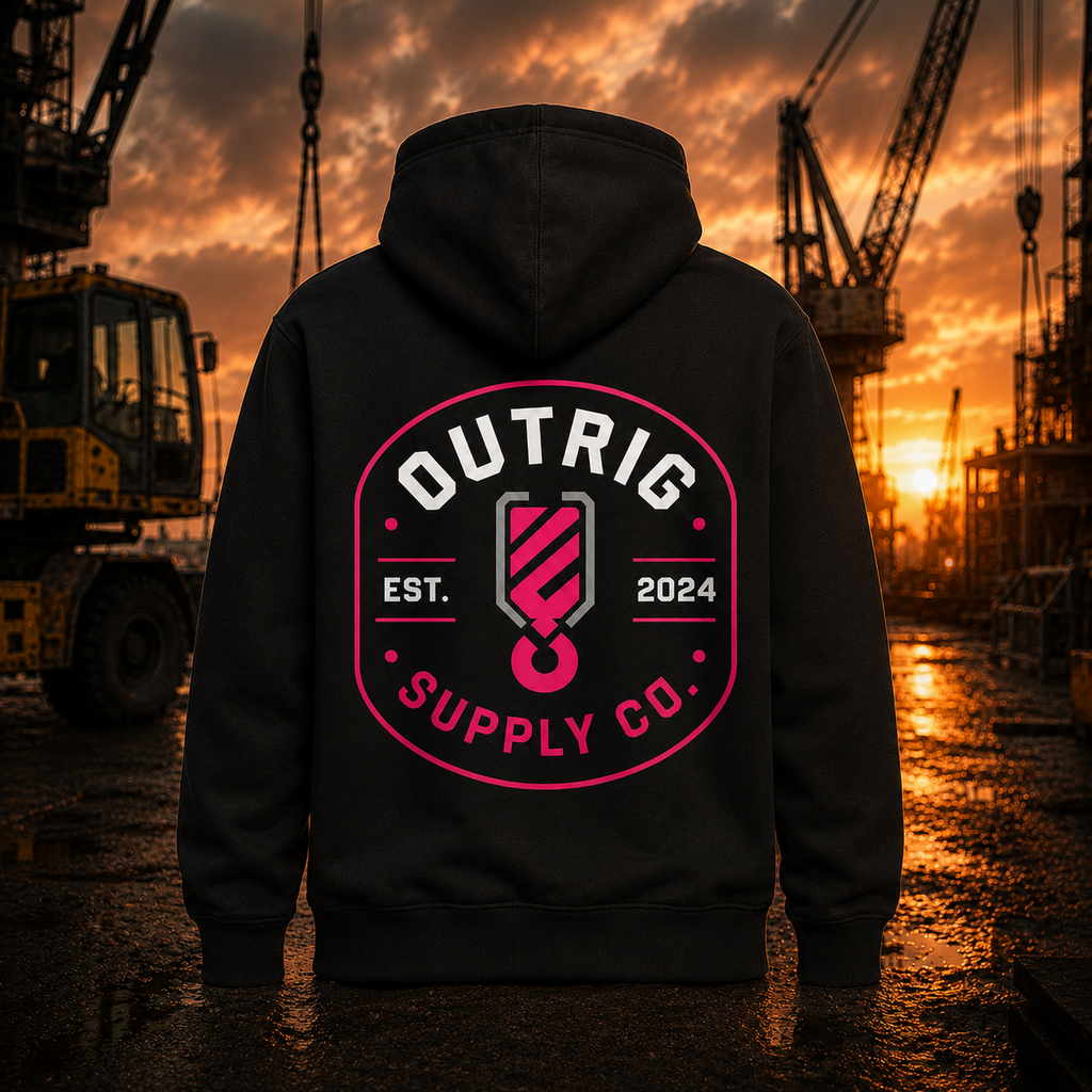 Person wearing a black hoodie with 'Outrig Supply Co.' logo at a construction site during sunset.